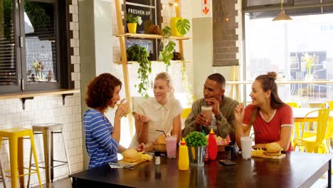 executives interacting while having lunch at table 4k