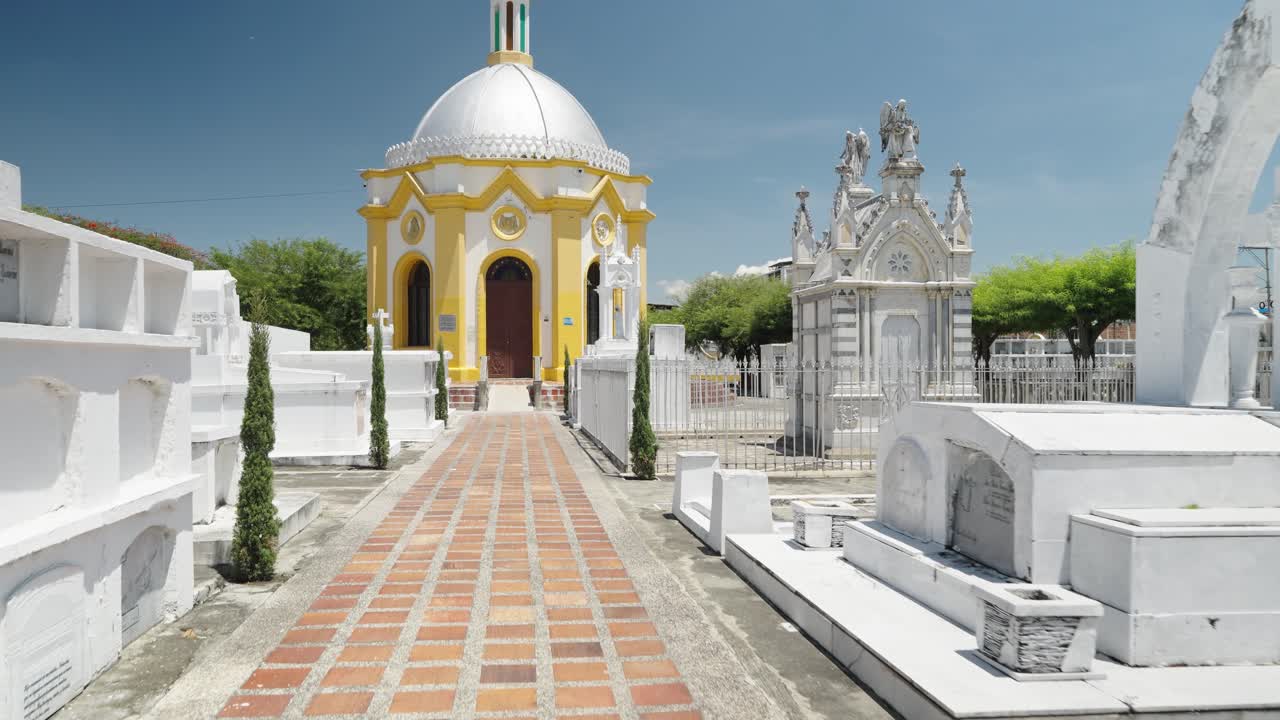 Footage of the Colombian national flag waving in the wind at the cemetery of El Cerrito Valle del Cauca Colombia showing patriotic symbol in cultural and historic context