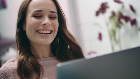 Happy-woman-laughing-looking-at-laptop-at-home.-Girl-making-online-video-call