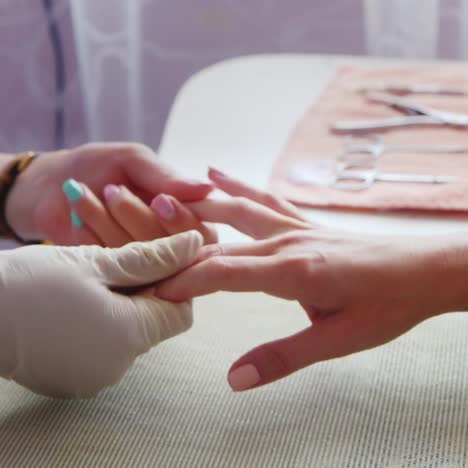 woman gives manicure in a salon