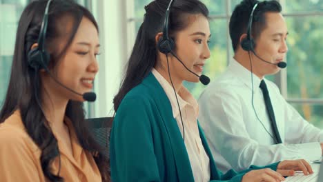 business people wearing headset working actively in office