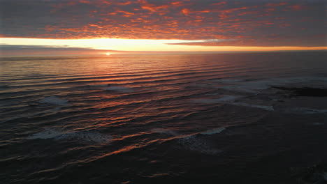 Establishing-Aerial-Drone-Shot-Over-Sea-at-Stunning-Sunrise-in-North-Yorkshire-at-Low-Tide-UK