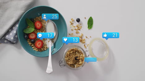 Eating granola and fruit with animation of social media notifications in kitchen