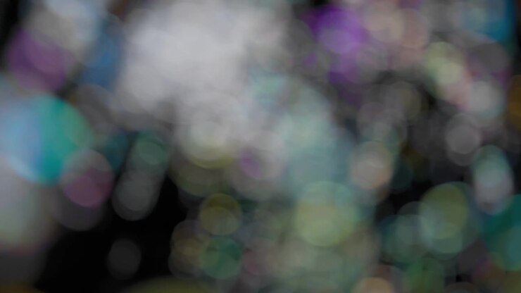 Abstract bokeh background of flying soap bubbles. Slow motion