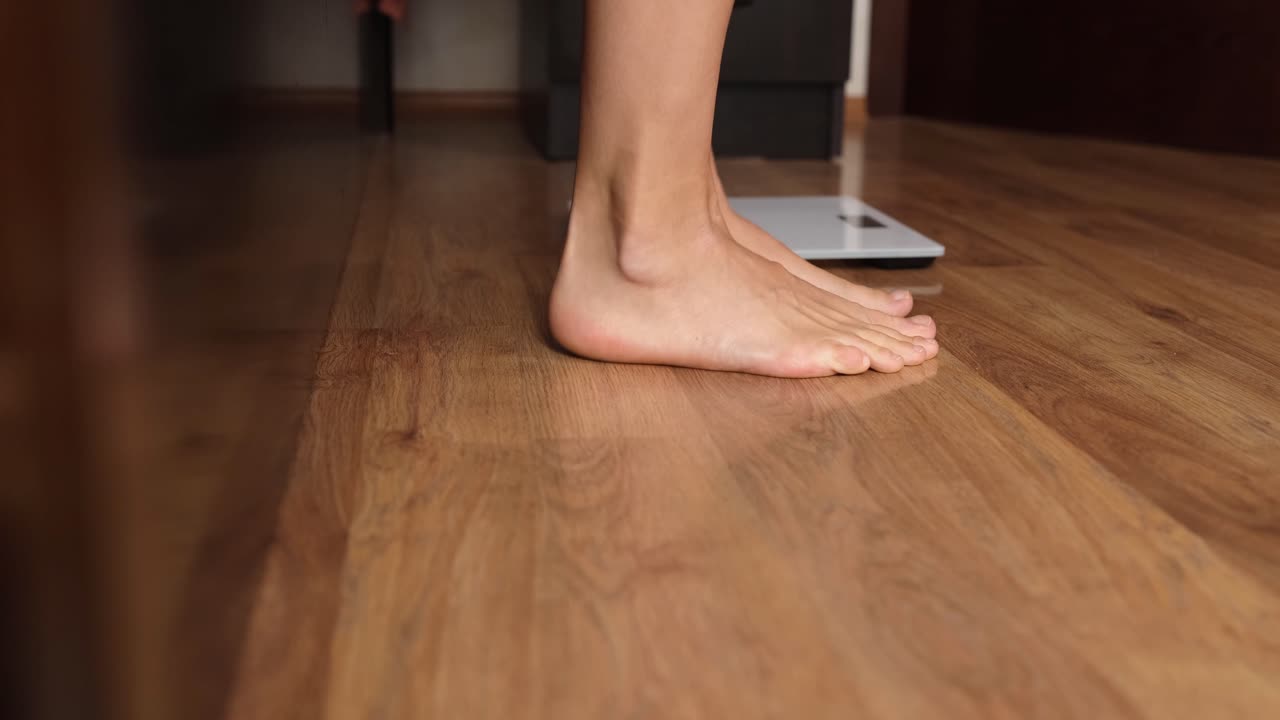 Women feet stepping on floor scales indoors