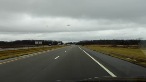 a drive down an open highway on a cloudy, overcast day