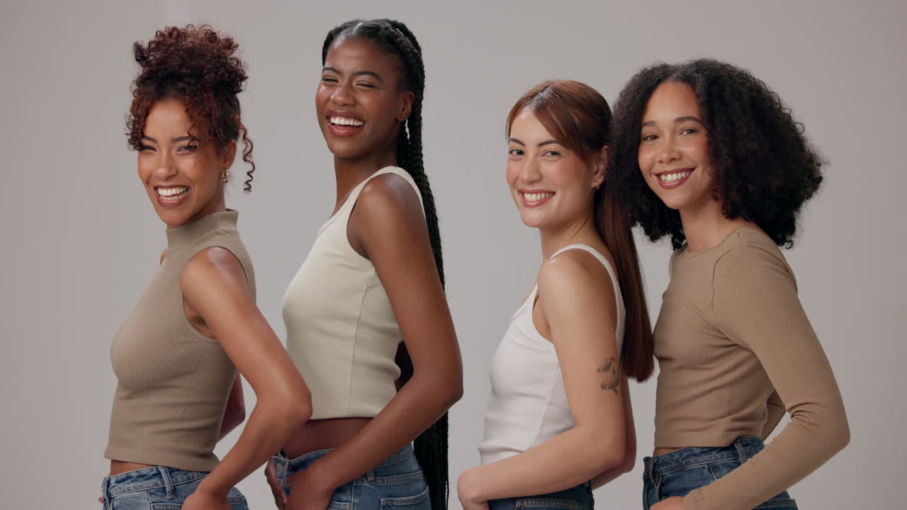 Four diverse women smiling and posing together