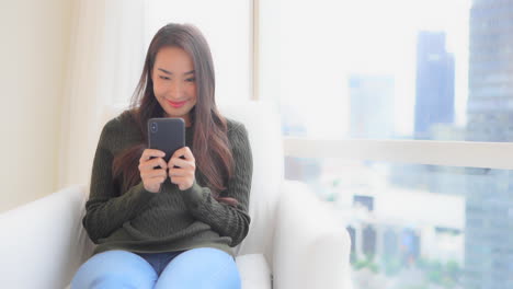 Asian-distracted-working-from-home-texting