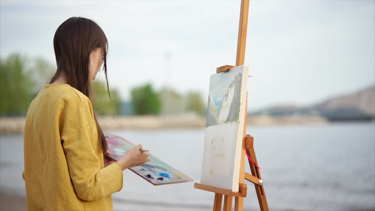 Woman Painting Landscape on the Beach