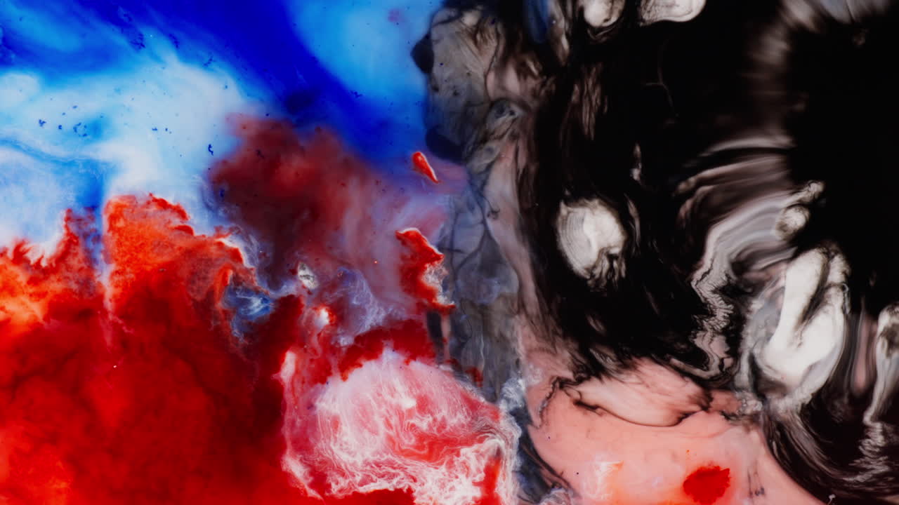 Red And Blue Inks, Contrasting With A Swirling Mix Of Black, White, And Grey Colors