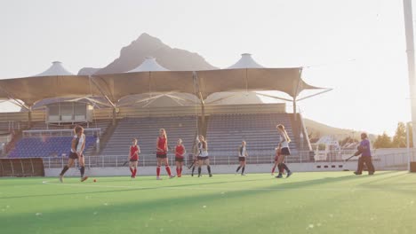 Female-hockey-players-playing-on-the-field