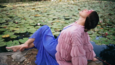 sensual model nymph sitting near forest pond landscape close up. romantic woman