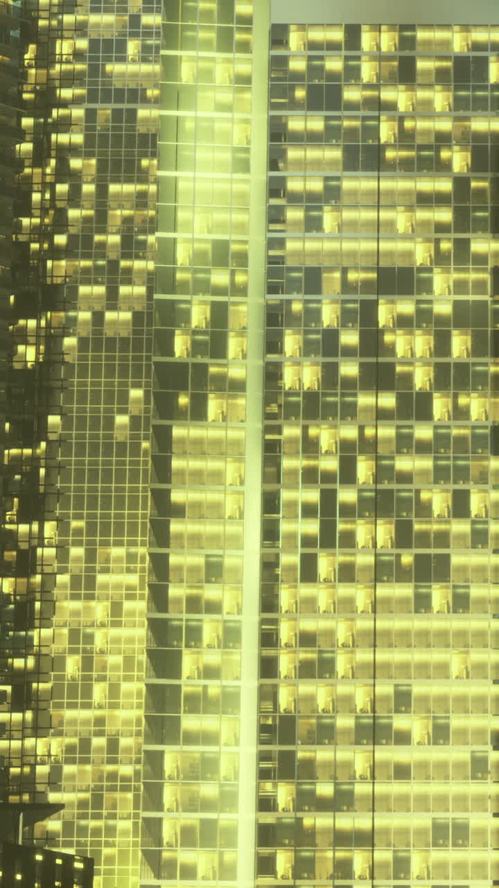 Skyscraper shines with golden lights in a vibrant city night scene