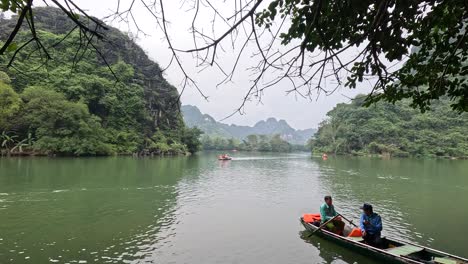 tourists rowing boat in tranquil river setting