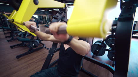 muscular man exercising in gym. athlete exercising using weight lifting machine to lose weight