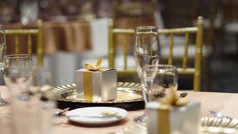 decorated table for wedding banquet with a gift box for guests