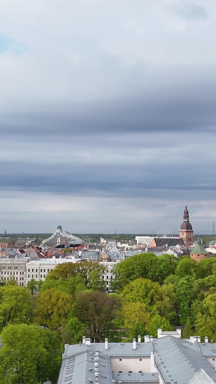 Riga City Skyline From Esplanade Park In Daytime In Latvia. - aerial vertical shot