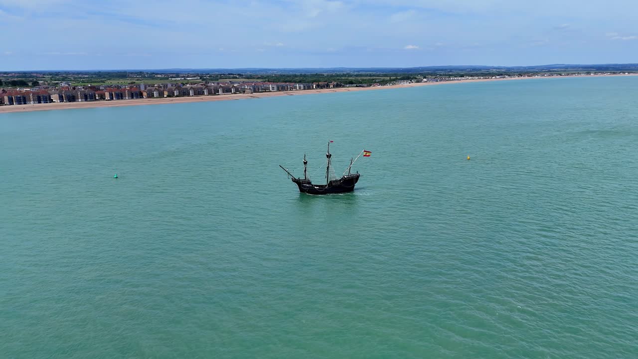 Cinematic drone footage of the majestic Nao Victoria ship navigating Sussex waters, showcasing a perfect blend of maritime history and the English coastal landscape.