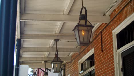 gas lantern hanging from balcony french quarter new orleans