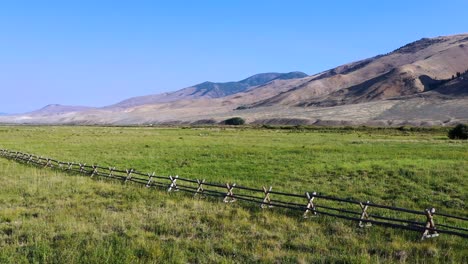 aerial push in on a pasture fence