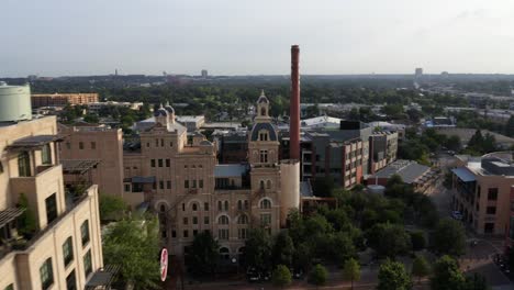 san antonio pearl district aerial view of park and tower, orbit and pan right showing historic warehouse buildings in the morning with 4k drone