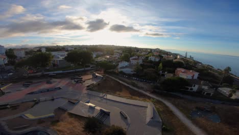 Aerial-of-large-skate-park-across-from-downtown-Cascais-with-a-huge-sunrise