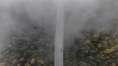 aerial footage of fog-clad highway 24 amidst autumn splendor