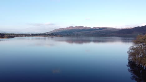 flying over beautiful scottish lake with ben lomond mountain in background