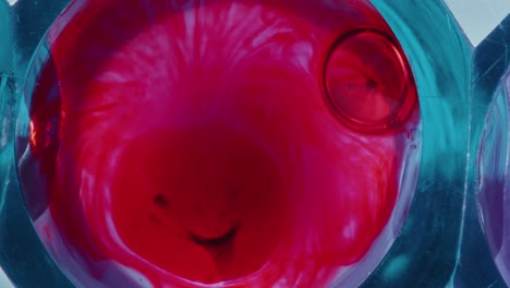 blood droplet slowly dissolving in liquid during chemical reaction