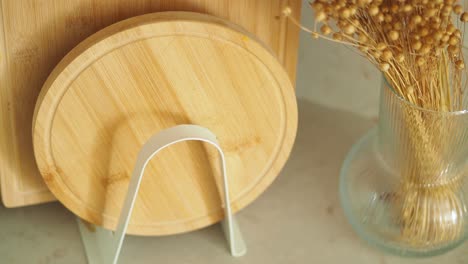 wooden cutting boards and dried decor on a kitchen countertop