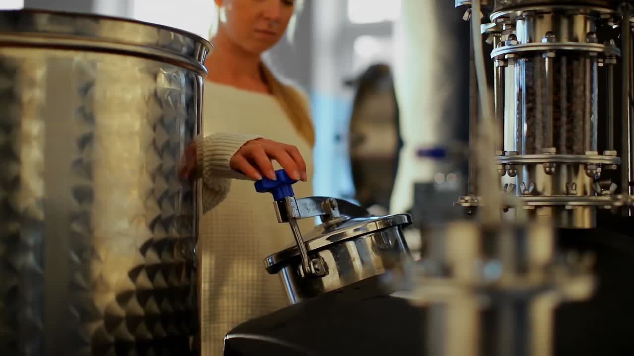 Female worker checking distillery tank 4k