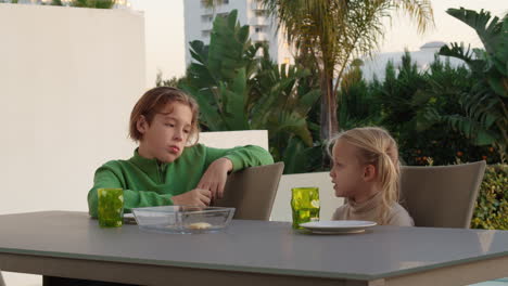 siblings enjoying pizza outdoors