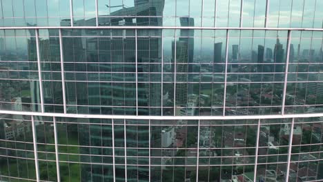 modern city skyscrapers reflected in glass facade