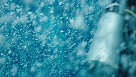scuba diver immersed in bubbles underwater
