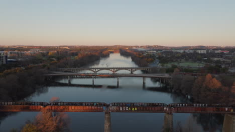 aerial of early morning aerial shot of river with three bridges crossing it