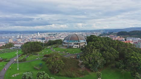 360âº viewpoint dome on hilltop with views to coastal cityscape