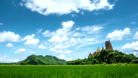 4k time-lapse, landscape beautiful sky with green cornfield at tiger cave temple (wat tham sua) in kanchanaburi province thailand