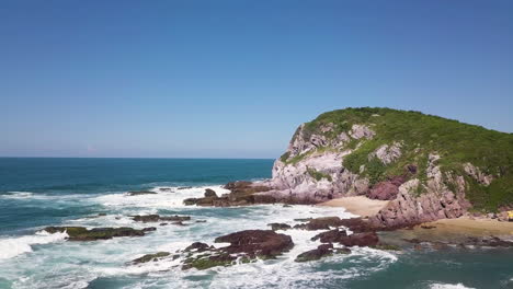 Blue-sea-waves-hitting-a-rocky-cape-background