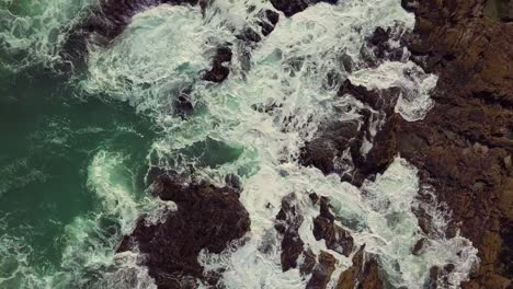 waves coming and going into a rocky shoreline off the coast of cape town, south africa
