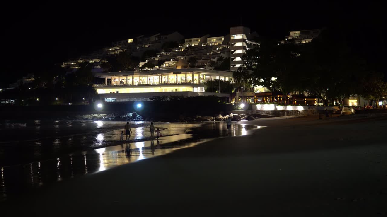 Night time on beach with city background