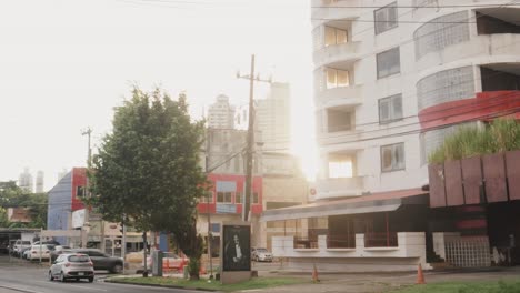 Camera-focuses-on-the-high-rise-building-situated-along-the-busy-road-side