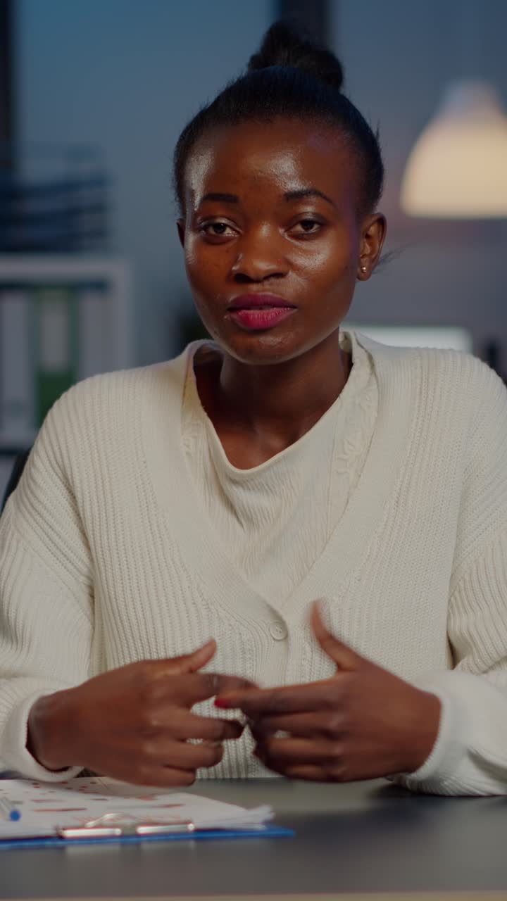 Vertical video Pov of african freelancer discussing online with colleague overworking