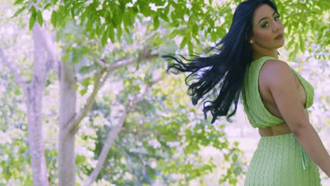 Beautiful-young-woman-in-a-green-dress-at-a-park