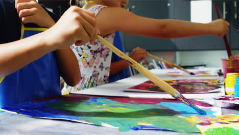 attentive schoolkids practicing drawing in drawing class