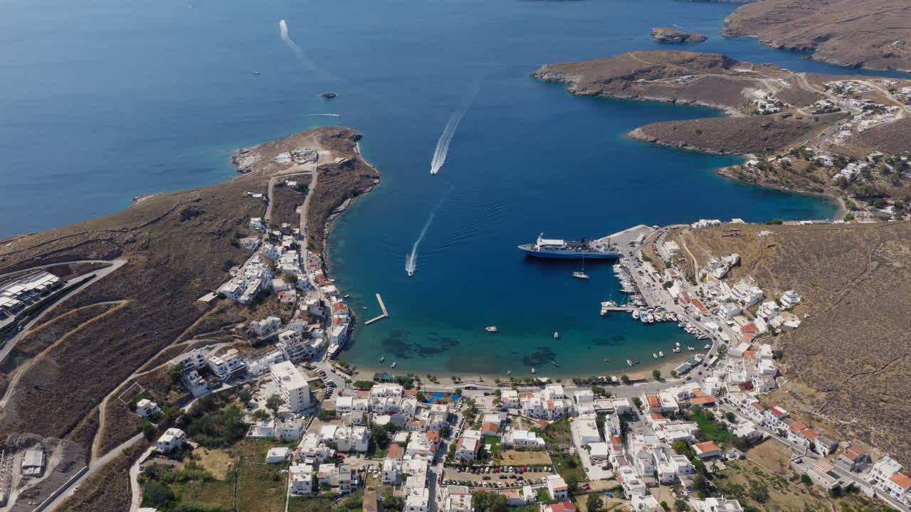 Aerial panorama of Merichas harbor and Gialos Beach on a bright summer day, highlighting Kythnos island’s coastal beauty