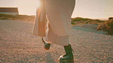 girl legs walking road in sunlight closeup. relaxed woman enjoy autumn evening