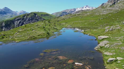 mountain lake lac guichard in french alps - aerial pedestal up