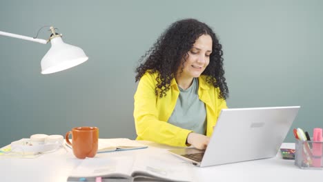 Young-woman-looking-at-laptop-is-happy-and-dancing.