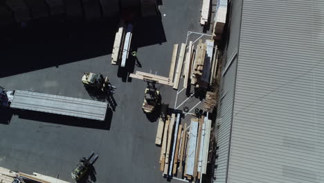 aerial video of a forklift moving around at a lumber yard