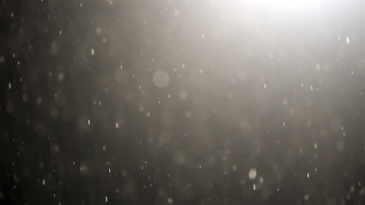 Slow Motion Rain Drops Falling at Night Against Light